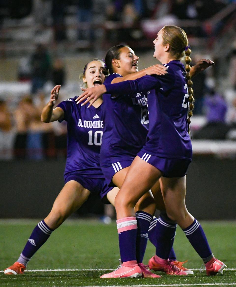 Bloomington South’s Ellie Barada (10) and Gianna Stanton congratulate Katharine Lacy (23) after her goal during the IHSAA girls’ soccer state championship match at Michael Carroll Track & Soccer Stadium in Indianapolis, Ind. on Saturday, Oct. 28, 2023.