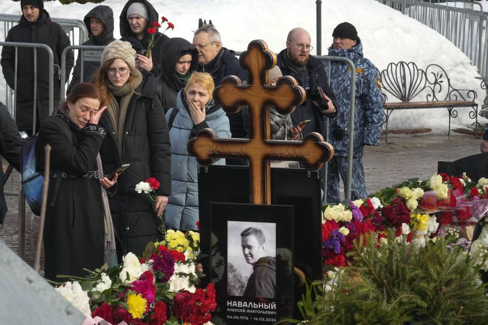 People react as they gather to lay flowers at the grave of Alexei Navalny after his funeral Friday at the Borisovskoye Cemetery, in Moscow, Russia, on Saturday, March 2, 2024. Navalny, who was President Vladimir Putin's fiercest foe, was buried after a funeral that drew thousands of mourners amid a heavy police presence. (AP Photo)