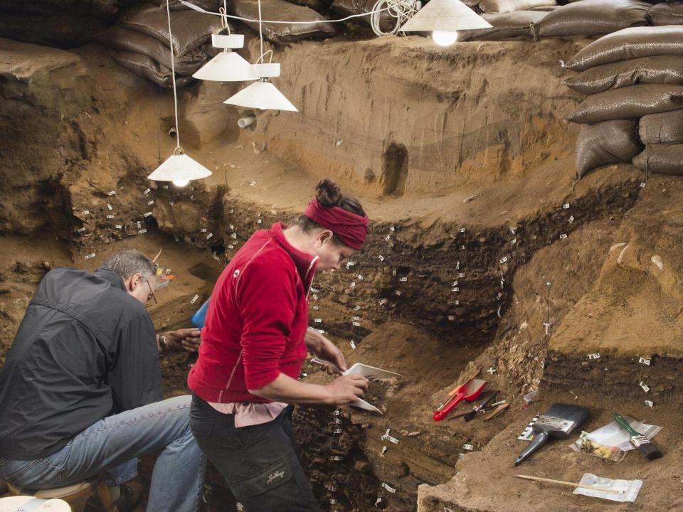 Archaeologists excavating inside Blombos cave (Magnus M. Haaland)