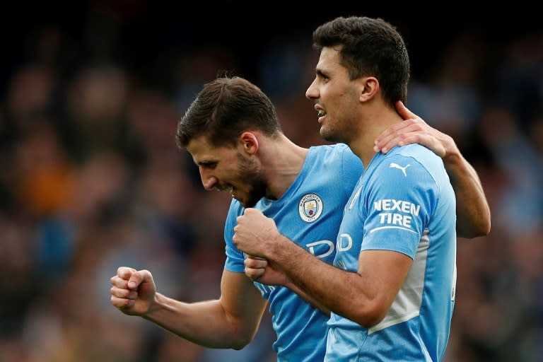 Rodri's(right)late winner at Arsenal opened up an 11-point Premier League lead for Manchester City (AFP/Adrian DENNIS)