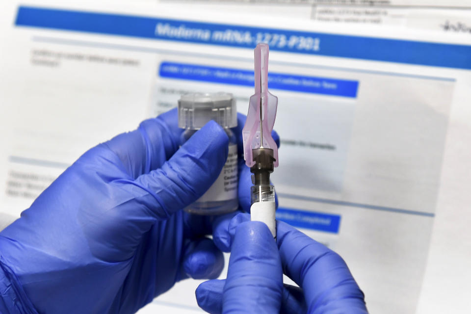 FILE - In this July 27, 2020, file photo, a nurse prepares a shot as a study of a possible COVID-19 vaccine, developed by the National Institutes of Health and Moderna Inc., gets underway in Binghamton, N.Y. The U.S. is poised to give the green light as early as Friday, Dec. 18, to a second COVID-19 vaccine, a critical new weapon against the surging coronavirus. Doses of the vaccine developed by Moderna Inc. and the National Institutes of Health will give a much-needed boost to supplies as the biggest vaccination effort in the nation’s history continues. (AP Photo/Hans Pennink, File)