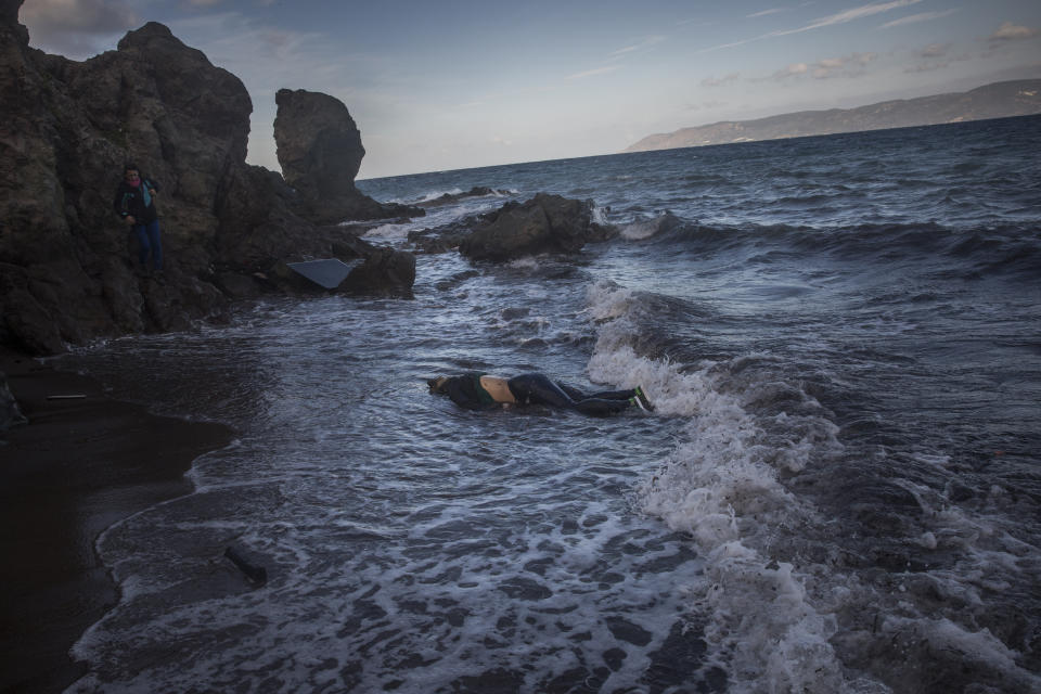 FILE - The lifeless body of an unidentified woman washes up on the shoreline at the village of Skala, on the Greek island of Lesbos, on Sunday, Nov. 1, 2015. The UN migration agency marks a decade since the launch of the Missing Migrants Project, documenting more than 63,000 deaths around the world. More than two-thirds of victims remain unidentified highlighting the size of the crisis and the suffering of families who rarely receive definitive answers. (AP Photo/Santi Palacios, File)