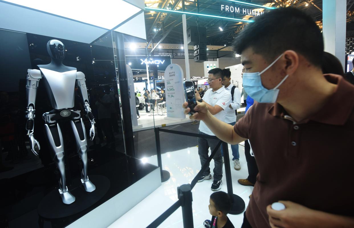 SHANGHAI, CHINA - JULY 6, 2023 - Spectators look at Tesla's 