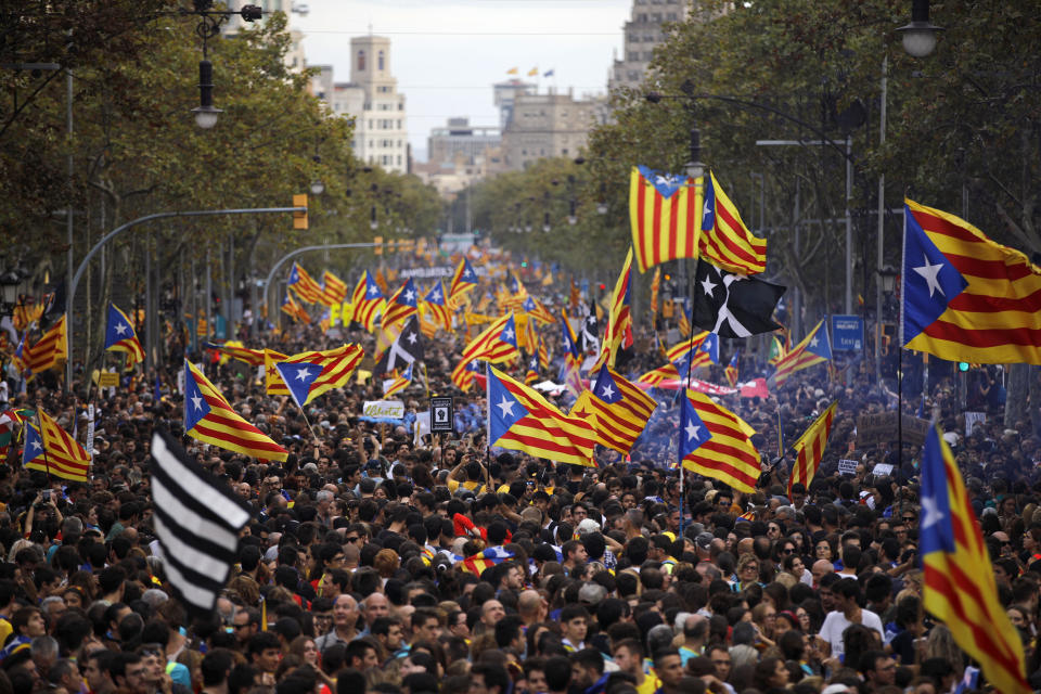 Protestors wave Estelada pro-independence flags during a demonstration in Barcelona, Spain, Friday, Oct. 18, 2019.The Catalan regional capital is bracing for a fifth day of protests over the conviction of a dozen Catalan independence leaders. Five marches of tens of thousands from inland towns are converging in Barcelona's center for a mass protest. (AP Photo/Emilio Morenatti)