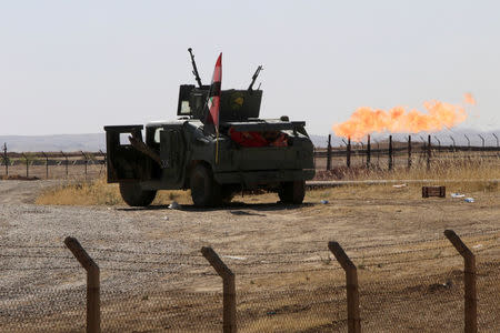 FILE PHOTO: Flames emerge from flare stacks at the oil fields in Dibis area on the outskirts of Kirkuk, Iraq October 17, 2017. REUTERS/Alaa Al-Marjani/File Photo