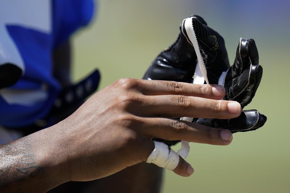 Los Angeles Rams wide receiver TuTu Atwell (15) tapes his fingers at the NFL football team's practice facility in Irvine, Calif. Monday, Aug. 8, 2022. (AP Photo/Ashley Landis)