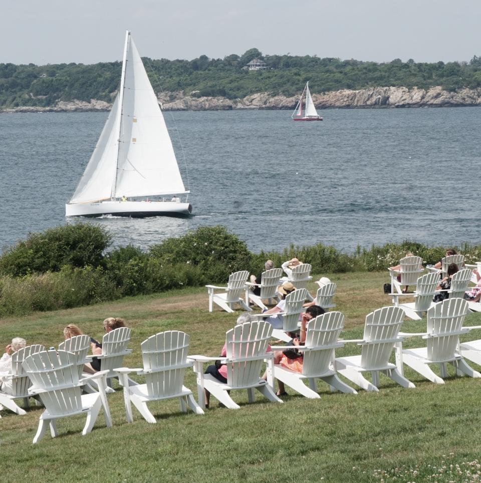 The view from the lawn chairs at Castle Hill Inn in Newport include boats sailing by.