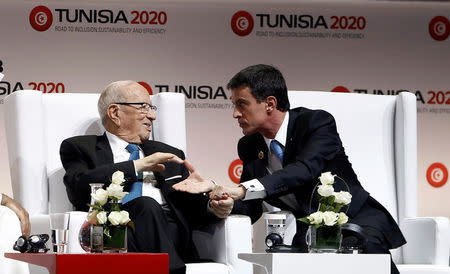 Tunisia's President Beji Caid Essebsi (L) shakes hands with French Prime Minister Manuel Valls at the opening of international investment conference Tunisia 2020, in Tunis, Tunisia November 29, 2016. REUTERS/Zoubeir Souissi