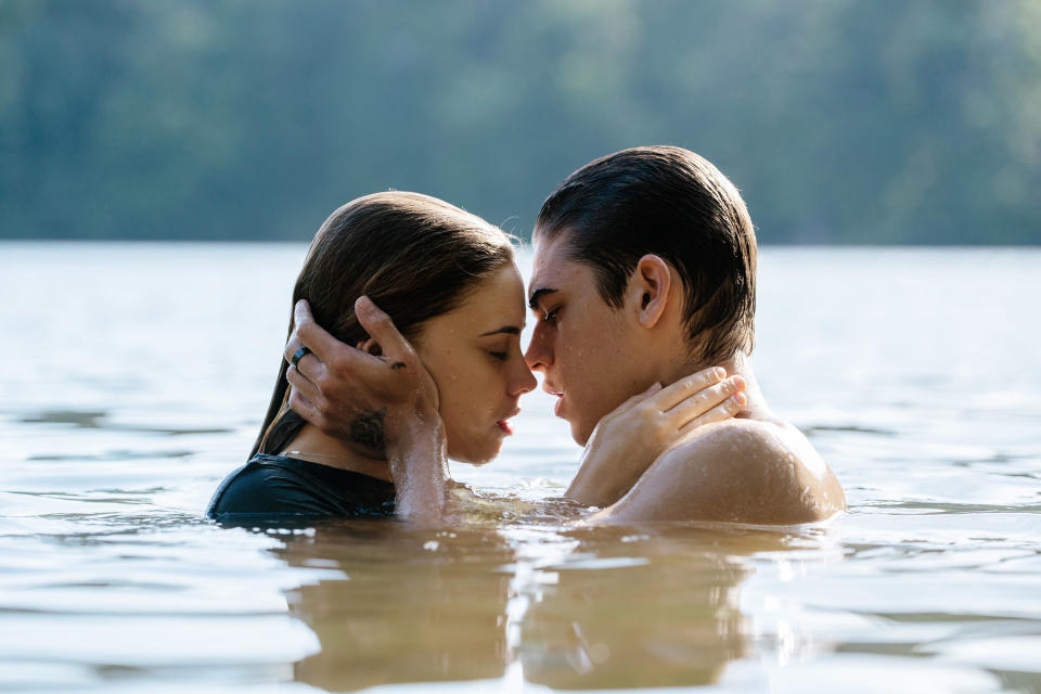 a guy and a girl in a lake about to kiss