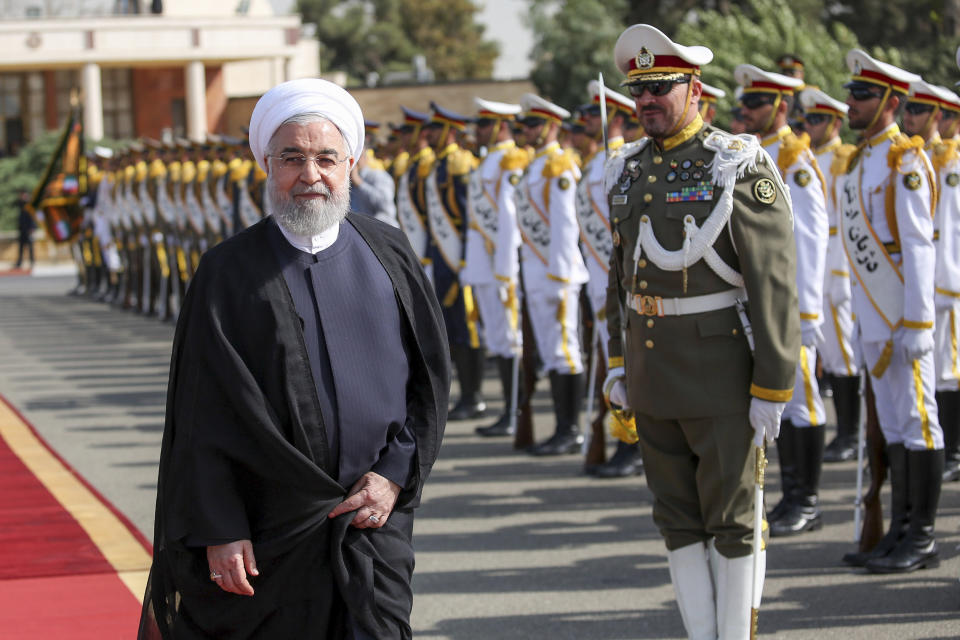 In this photo released by the official website of the office of the Iranian Presidency, President Hassan Rouhani reviews an honor guard at the Mehrabad airport while leaving Tehran, Iran, for New York to attend United Nations General Assembly, Monday, Sept. 23, 2019. Rouhani, before traveling to attend the U.N. meetings, said Monday that Iran will invite "all littoral states of the Persian Gulf" to join its coalition "to guarantee the region's security." (Iranian Presidency Office via AP)