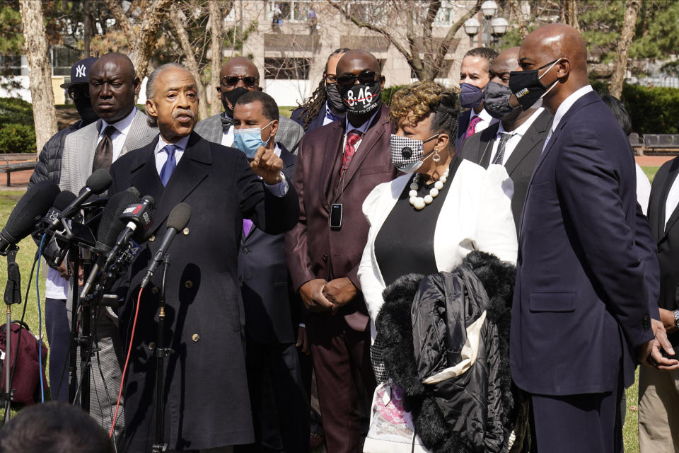 The Rev. Al Sharpton, left, addresses the media before giving a prayer as he, members of George Floyd's family along with Gwen Carr, the mother of Eric Garner gathered outside the Hennepin County Government Center during lunch break, Tuesday, April 6, 2021, in Minneapolis where testimony continues in the trial of former Minneapolis police officer Derek Chauvin. Chauvin is charged with murder in the death of George Floyd during an arrest last May. (AP Photo/Jim Mone)