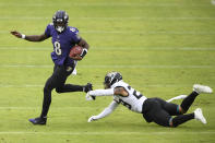 Baltimore Ravens quarterback Lamar Jackson (8) avoids a sack attempt by Jacksonville Jaguars safety Josh Jones (29) during the second half of an NFL football game, Sunday, Dec. 20, 2020, in Baltimore. (AP Photo/Nick Wass)