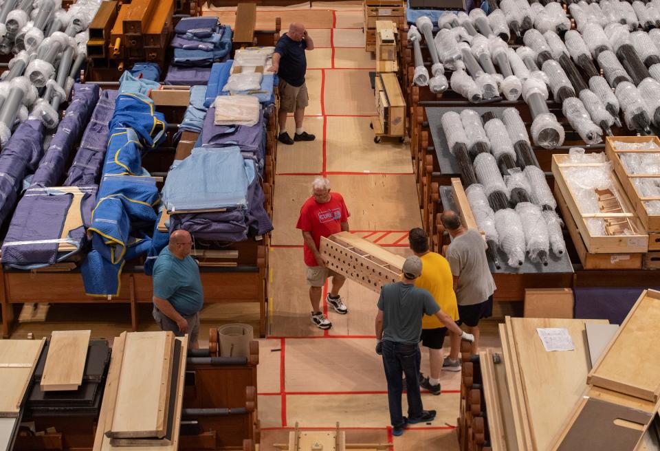 People move pieces of the new organ through St. Benedict Cathedral in Evansville, Ind., Wednesday, July 10, 2024.