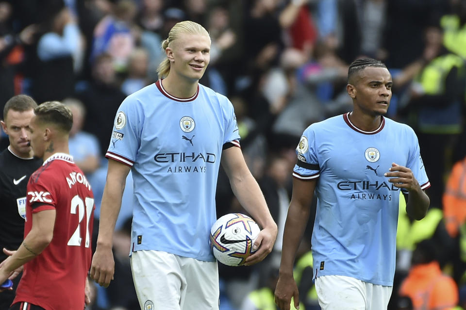 Manchester City's Erling Haaland holds the ball at the end of the English Premier League soccer match between Manchester City and Manchester United at Etihad stadium in Manchester, England, Sunday, Oct. 2, 2022. Manchester City won 6-3 and he scored an hat trick. (AP Photo/Rui Vieira)