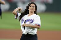 American actor Eva Longoria throws out the ceremonial first pitch before the baseball game between the St. Louis Cardinals and the Texas Rangers, Wednesday, June 7, 2023, in Arlington, Texas. (AP Photo/Jim Cowsert)