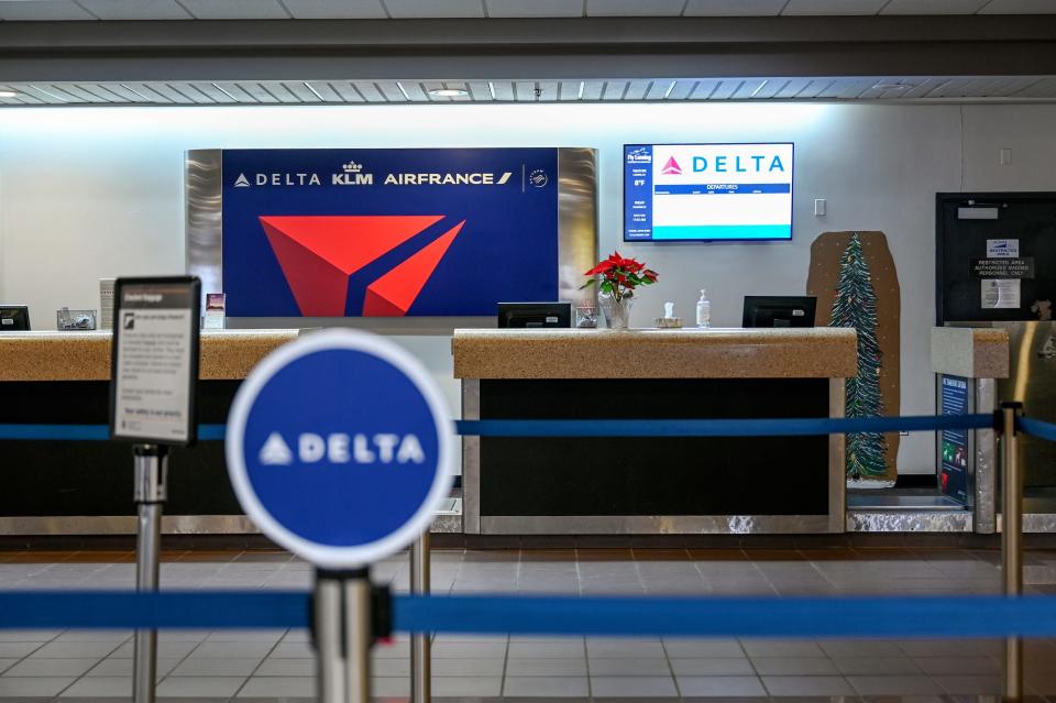 The Delta ticket counter is empty after flights on the carrier were cancelled on Friday, Dec. 23, 2022, in Lansing.