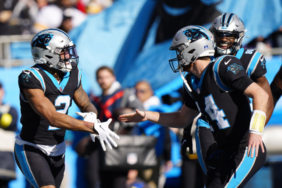 Carolina Panthers wide receiver DJ Moore celebrates after scoring with quarterback Sam Darnold during the first half of an NFL football game between the Carolina Panthers and the Pittsburgh Steelers on Sunday, Dec. 18, 2022, in Charlotte, N.C. (AP Photo/Jacob Kupferman)