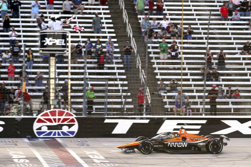 Pato O'Ward celebrates his victory at an IndyCar Series auto race at Texas Motor Speedway on Sunday, May 2, 2021, in Fort Worth, Texas. (AP Photo/Richard W. Rodriguez)