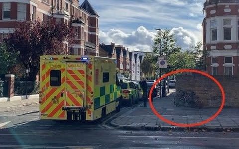 An ambulance arrives on Chiswick High Road in the aftermath of the cycling accident