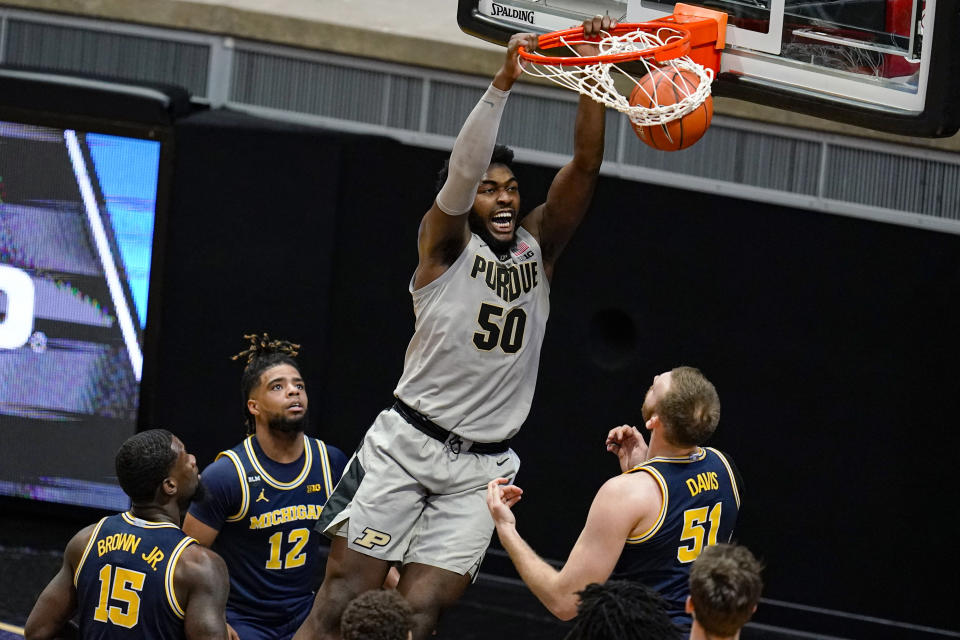 Purdue forward Trevion Williams (50) dunks over Michigan forward Austin Davis (51) during the first half of an NCAA college basketball game in West Lafayette, Ind., Friday, Jan. 22, 2021. (AP Photo/Michael Conroy)