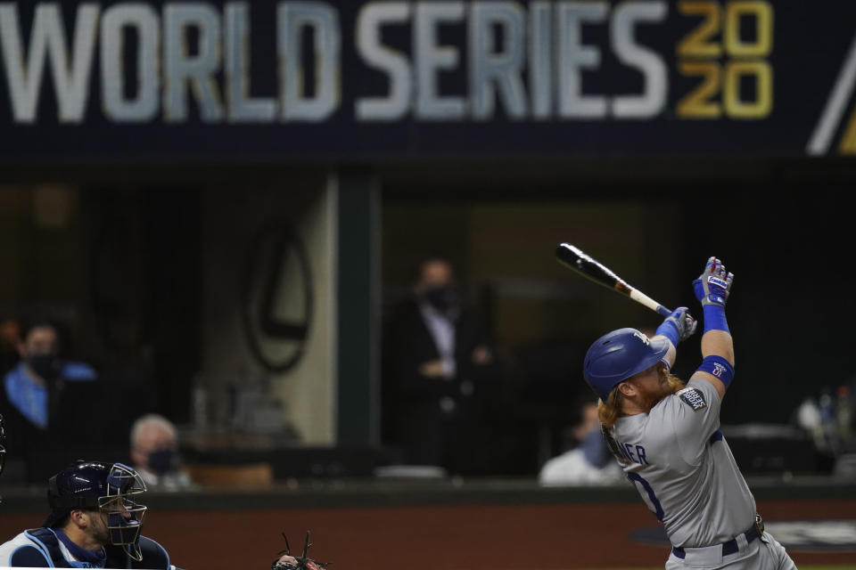 Los Angeles Dodgers' Justin Turner watches his home run against the Tampa Bay Rays during the first inning in Game 3 of the baseball World Series Friday, Oct. 23, 2020, in Arlington, Texas. (AP Photo/Eric Gay)