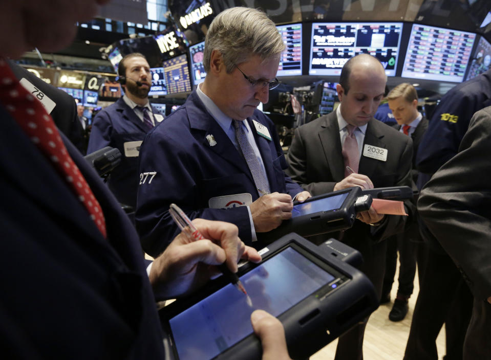 Traders work on the floor of the New York Stock Exchange Wednesday, Feb. 5, 2014. The U.S. stock market is edging lower in early trading after a modest recovery the day before. (AP Photo/Richard Drew)