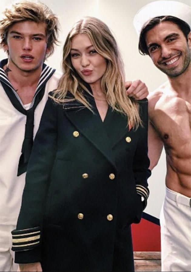 Gigi poses alongside hunky models for her new campaign.