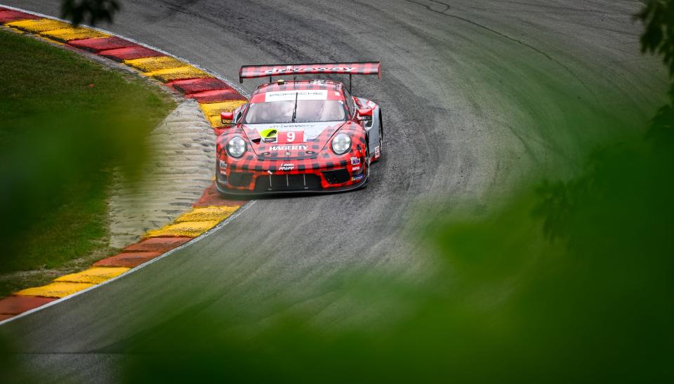 The plaid Pfaff Motorsports Porsche of Matt Cambell and Mathieu Jaminet passes through Turn 12 – Canada Corner – during practice Friday at Road America.