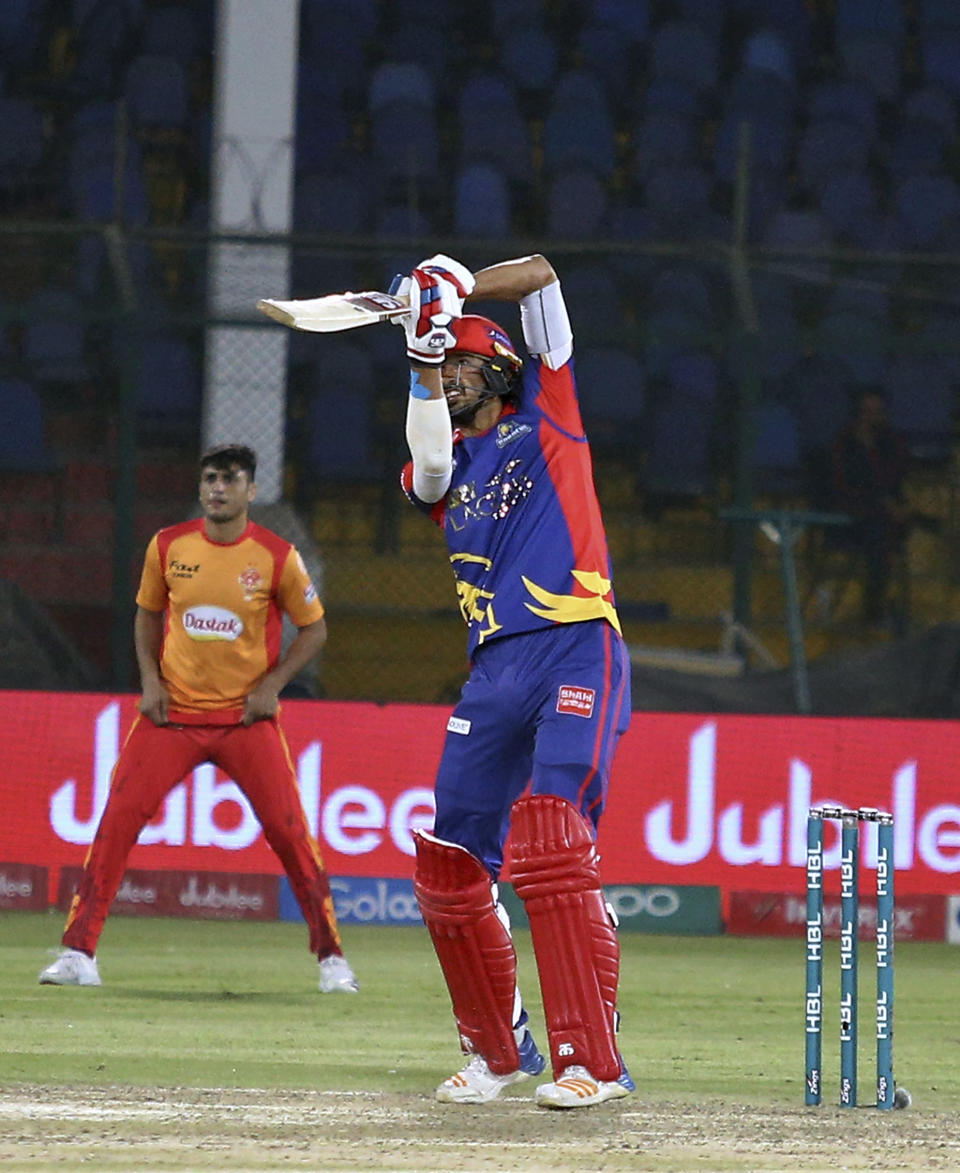 Karachi Kings batsman Umaid Asif, right, plays a winning shot during a Pakistan Super League T20 cricket match against Islamabad United at the National Stadium in Karachi, Pakistan, Saturday, March 14, 2020. (AP Photo/Fareed Khan)