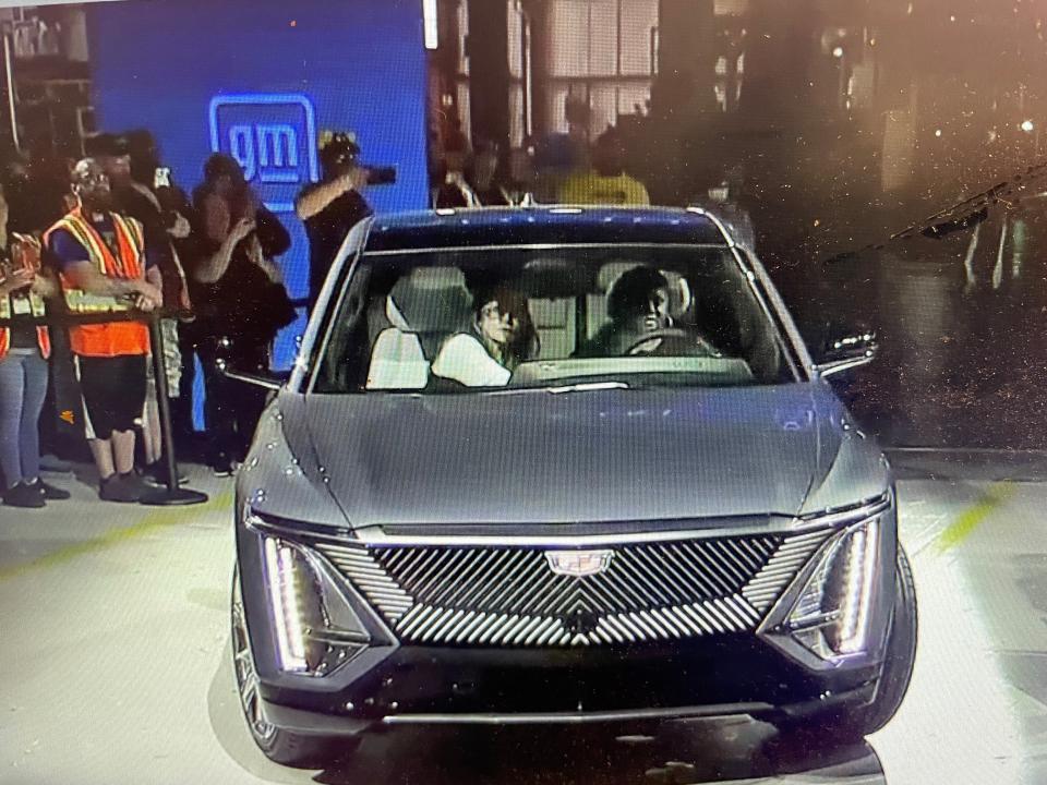 The 2023 Cadillac Lyriq electric SUV is driven on stage by two autoworkers to mark the start of production on March 21, 2022.