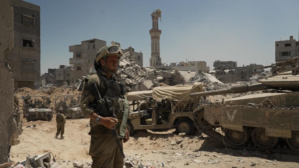 An Israeli Defense Forces soldier stands in front of military vehicles in the southern Gaza city of Rafah, during ongoing IDF operations against Hamas in the city, July 3, 2024. / Credit: CBS News