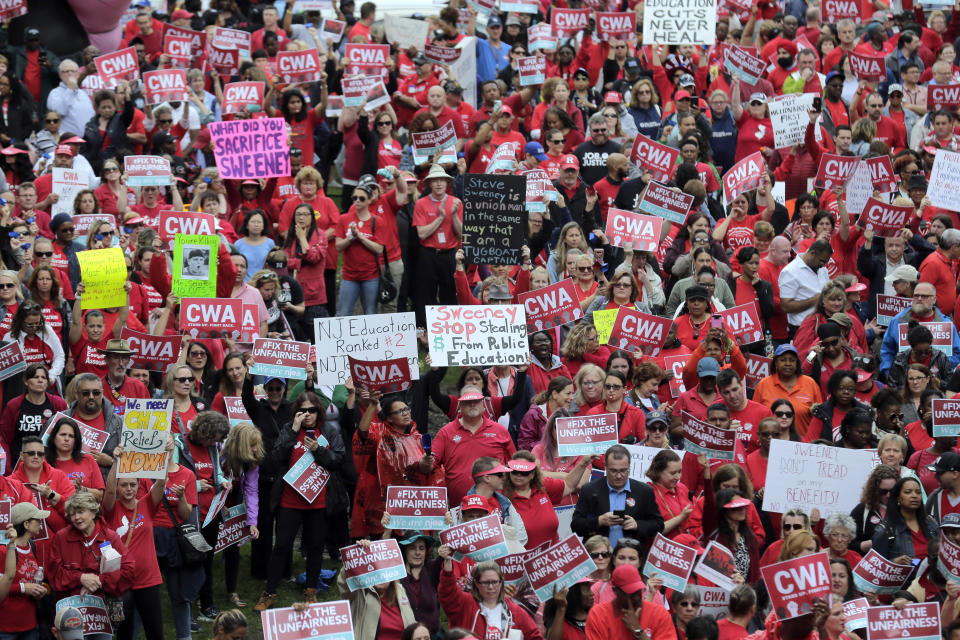 Protesters rally against benefit cuts in Trenton, N.J., Thursday, June 13, 2019. Spurred on by a tweet from U.S. Sen. Bernie Sanders, thousands of union members crowded around New Jersey's legislative annex Thursday, even spilling into the street, to protest state Senate President Steve Sweeney's calls to cut some worker benefits. (AP Photo/Seth Wenig)