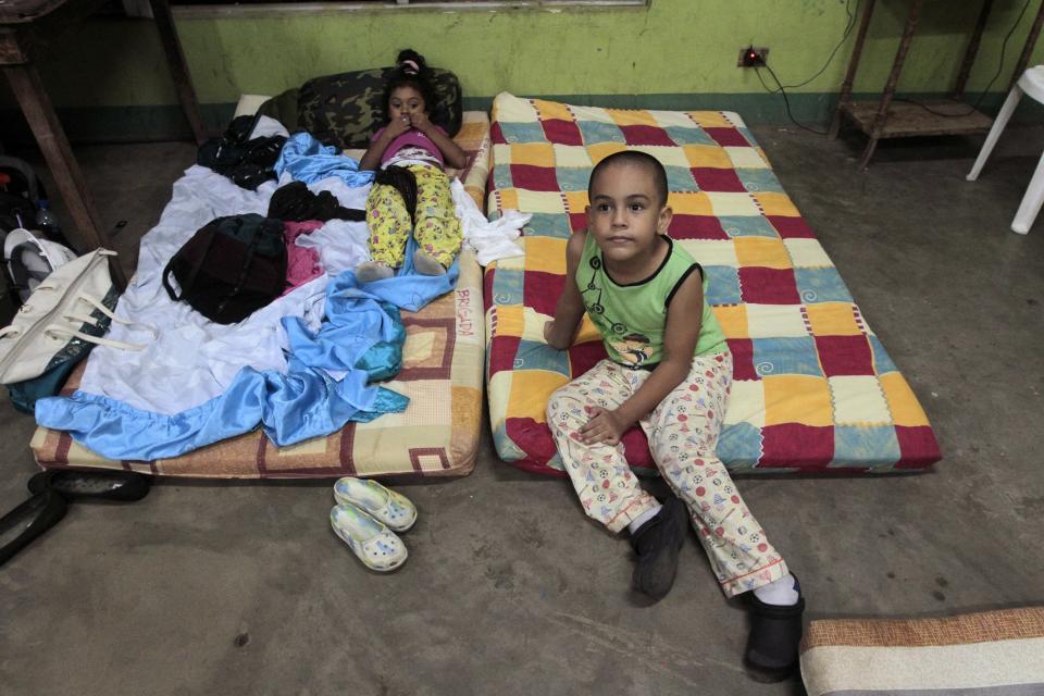 Children sit inside an evacuation center in Managua after an earthquake shook Nicaragua October 13, 2014. A magnitude 7.3 earthquake struck late on Monday off the coast of El Salvador and Nicaragua and was felt across Central America, killing at least one person, but there were no immediate reports of major damage. The quake struck 42 miles (67 km) west-southwest of Jiquilillo in Nicaragua and 174 km southeast of San Salvador, the U.S. Geological Survey said. It said the quake hit at a depth of about 25 miles (40 km). (REUTERS/Oswaldo Rivas)