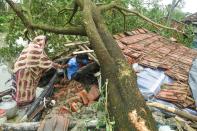 Villagers salvage items from their house damaged by cyclone Amphan in Midnapore, West Bengal, on May 21, 2020. - The strongest cyclone in decades slammed into Bangladesh and eastern India on May 20, sending water surging inland and leaving a trail of destruction. (Photo by DIBYANGSHU SARKAR/AFP via Getty Images)