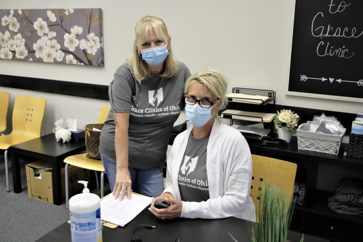 Registered Nurse Colleen Freed and Executive Director Melissa Mason, seated, wait for patients to arrive on Monday, June 20, 2022, at Grace Clinic Marion, located in the Leapin' Outreach Center facility at 148 Court St. in downtown Marion. The free clinic opened in Marion earlier this year. Grace Clinic was established in 2006 in Delaware County and now has four locations.