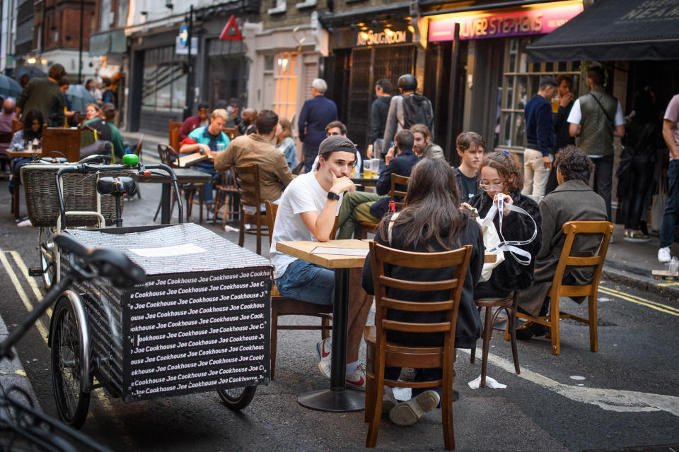 People eat and drink oudoors in Soho, London, as coronavirus lockdown restrictions are eased across England. Many streets in Soho were pedestrianised for the night, and bars and restaurants added extra outdoor seating. Picture date: Sunday July 5, 2020. Photo credit should read: Matt Crossick/Empics