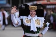 A woman dressed in a Northern German costume participates in the riflemen's parade.