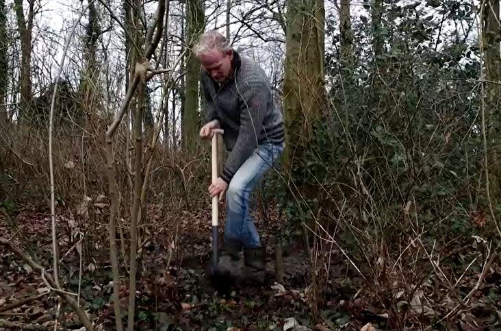 Metal detectorist and treasure hunter Jan Henzen digs into soil near the village of Ommeren, in the Netherlands, hoping to find riches buried during World War II by Nazi German soldiers. / Credit: Reuters