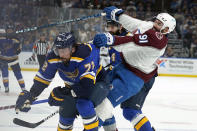 Colorado Avalanche's Nazem Kadri (91) collides with St. Louis Blues' Justin Faulk (72) during the first period in Game 3 of an NHL hockey Stanley Cup second-round playoff series Saturday, May 21, 2022, in St. Louis. (AP Photo/Jeff Roberson)