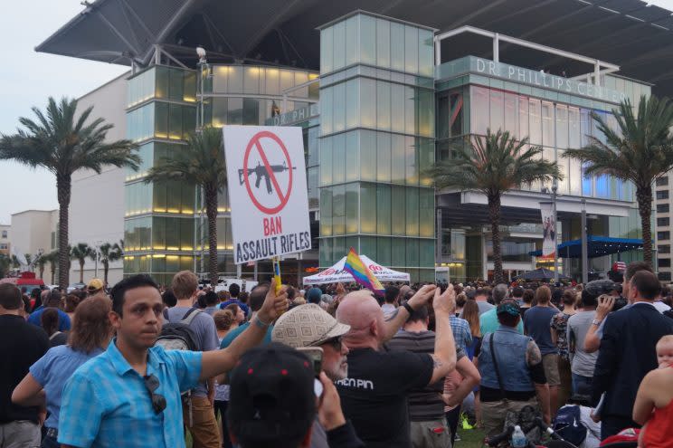 Fernando Uribe-Romo campaigns for stricter gun control during the vigil in downtown Orlando on Monday. (Photo: Michael Walsh/Yahoo News)