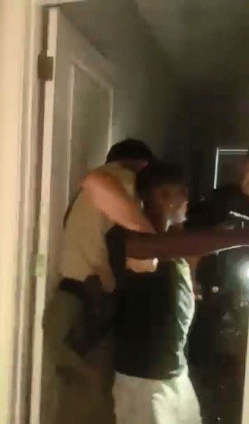 PHOTO: Brandon Calloway is held by police officers in a still image from video taken by Calloway's girfriend Tamia Caldwell, on July 16, 2022, showing the altercation with police that left him injured. (Tamia Caldwell via André C. Wharton, Esq.)