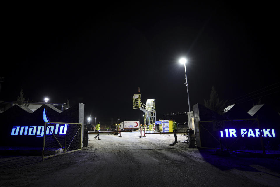 Security personnel stand at the entrance of the Copler gold mine near Ilic village, eastern Turkey, Tuesday, Feb. 13, 2024. A huge landslide hit a gold mine in eastern Turkey on Tuesday, trapping at least nine workers underground, officials said. (Ugur Yildirim/Dia images via AP)