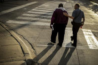 FILE - This photo from Wednesday June 3, 2020, shows Kansas City Police Chief Rick Smith, right, and Bishop Tony Caldwell, left, walking away for a private chat, during protests against police brutality in Kansas City, Mo., following the death of George Floyd in Minneapolis. The chaos unleashed in 2020, amid the coronavirus pandemic, has created space for different voices to speak, for different conversations to be had and for different questions to be asked. (AP Photo/Charlie Riedel, File)