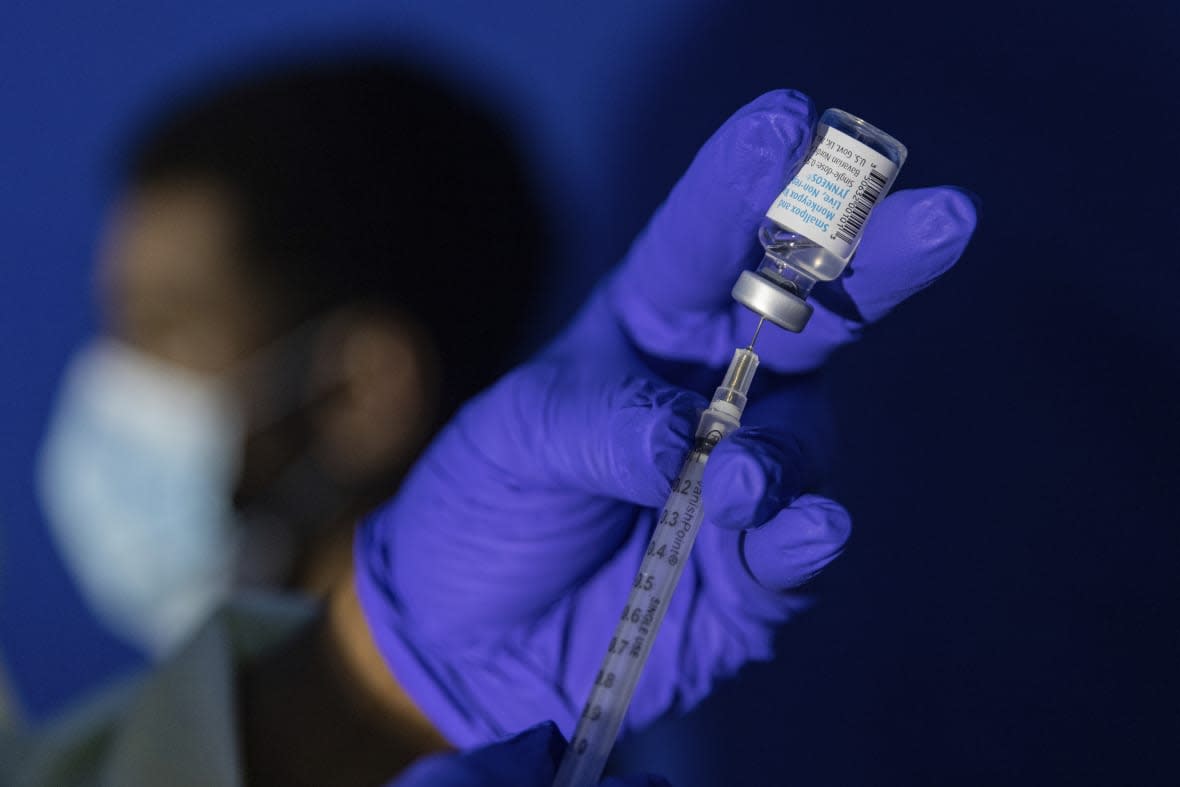 FILE – Family nurse practitioner Carol Ramsubhag-Carela prepares a syringe with the Mpox vaccine before inoculating a patient at a vaccinations site on Tuesday, Aug. 30, 2022, in the Brooklyn borough of New York. Africa’s public health body said Thursday, Feb. 16, 2023 it hopes Mpox vaccines will finally arrive on the continent “in another two weeks, tops” after months of seeking doses. (AP Photo/Jeenah Moon, File)