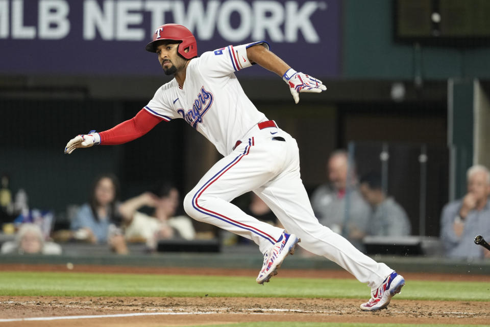 Texas Rangers' Marcus Semien (2) runs towards first as he grounds out during the seventh inning of a baseball game, Wednesday, June 7, 2023, in Arlington, Texas. Semien failed to get a hit ending his twenty five game streak. (AP Photo/Jim Cowsert)