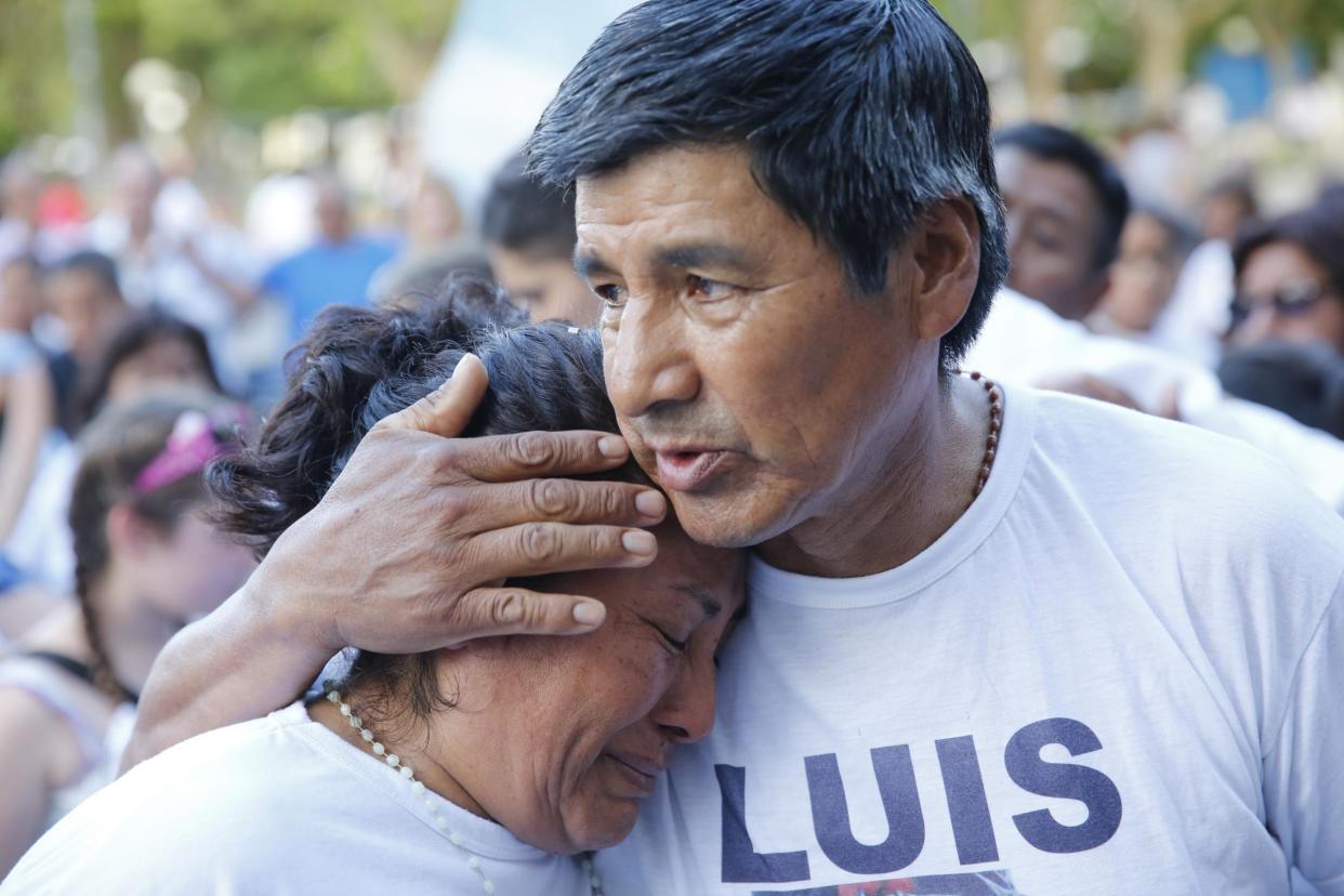 A man embraces a woman during a march organized by families of the 44 crew members of the submarine ARA San Juan: AP