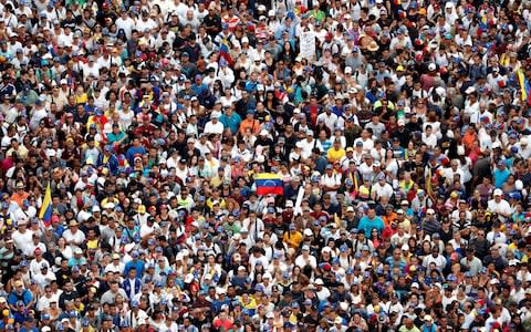 Thousands were beginning to assemble in Caracas ahead of the rival demonstrations on Wednesday - Credit: CARLOS GARCIA RAWLINS/REUTERS