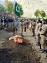 Pakistani troops lay a wreath at the grave of a soldier killed in firing along the Line of Control that divides the disputed territory of Kashmir, during his funeral in the Astore district of the Gilgit-Baltistan region