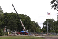 Workers dig up the remains of Confederate Gen. Nathan Bedford Forrest and his wife to move the bodies from Health Sciences Park June 4, 2021, in Memphis, Tenn. With the approval of relatives, the remains will be moved to the National Confederate Museum in Columbia, Tenn. (AP Photo/Karen Pulfer Focht)