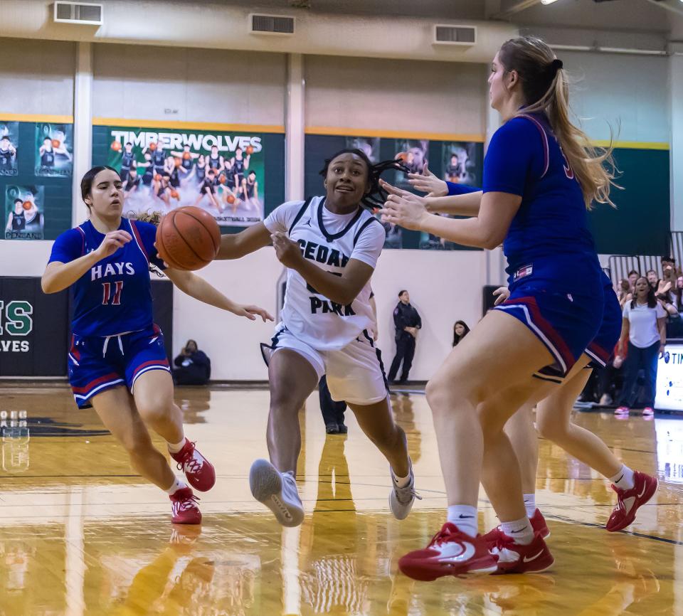 Cedar Park guard Hope Edwards drives to the basket against Hays defenders during their Jan. 26 game at Cedar Park. The state playoffs begin this week throughout the Austin area and the state.